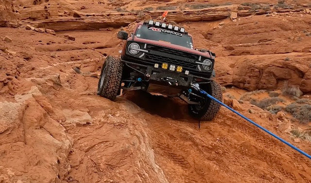 Off-road vehicle with winch mounted